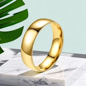 Polished 18K gold-plated minimalist dome ring displayed on white marble base