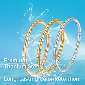 Three titanium steel bangles in gold, silver and rose gold finishes with textured design