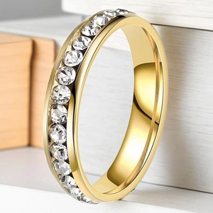 Detailed close-up of gold stainless steel ring with channel-set clear zircon stones