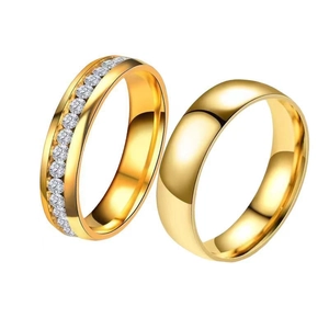 Polished gold stainless steel couple rings with one featuring a row of inlaid cubic zirconia