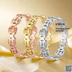 Hollow stainless steel coin rings in gold, rose gold and silver finishes on silk fabric