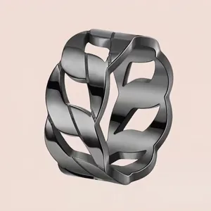 Titanium steel chain link ring in gunmetal black finish on a pink background