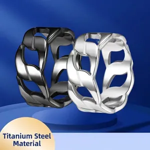 Titanium steel rings in silver and black featuring hollow chain texture on blue pedestal
