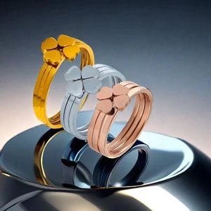 Detailed view of three-color clover rings in gold, silver, and rose gold stainless steel