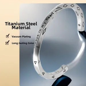 Detail of silver titanium steel bangle with always in my heart engraving and plating