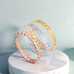 Detailed view of hollow chain link bangle in rose gold, silver and gold finish