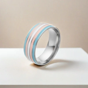 Macro detail of silver titanium steel ring with light blue and pink enamel stripes