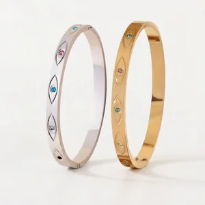 Brazaletes de acero inoxidable oro 18K y plata con motivos de ojos y piedras