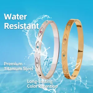 Brazaletes de acero de titanio con incrustaciones de ojos de circón de colores en oro y plata
