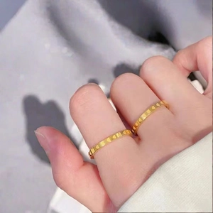 Minimalist 18k gold heart engraved stainless steel couple rings shown on hand