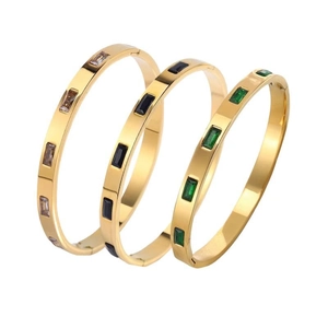 Three-piece gold plated stainless steel bangles with rectangular emerald black and champagne gems