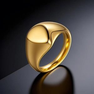 Polished gold stainless steel signet ring with minimalist fluid design on dark mirror