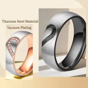 Polished stainless steel couple rings set with interlocking heart and matte finish
