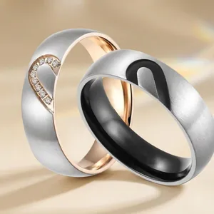 Polished titanium steel couple rings with interlocking heart design and zircon inlay