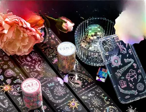 Close-up of laser-cut PET decorative tape with holographic floral and whale patterns
