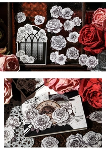 Detailed view of vintage rose and gothic clock stickers for scrapbook decoration