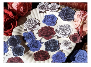 Close-up of vintage rose scrapbooking stickers with floral patterns on an antique background