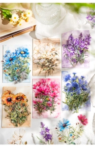 Flat lay of vintage PET floral stickers with blue cosmos and lace for scrapbooking