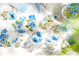 Detail of floral PET stickers featuring watercolor blue daisies and yellow blossoms on lace