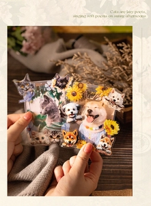 Detailed view of cat and dog acrylic photo holders with floral illustrations on desk