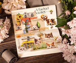 Macro detail of PET tape stickers featuring cute cat and dog illustrations in a scrapbook