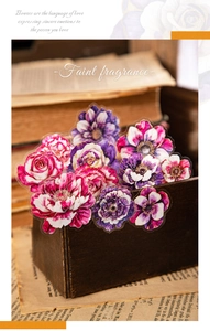 Close-up of vintage floral PET stickers with roses and carnations in a wooden box