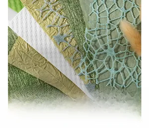 Macro view of textured lace and hollowed mesh paper for scrapbooking and DIY collage
