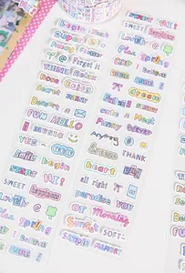 Close-up of pastel macaron-colored English script stickers for DIY journaling