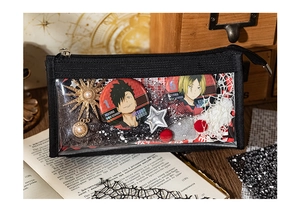 Close-up of a black transparent mesh storage bag with anime character pins and star charms