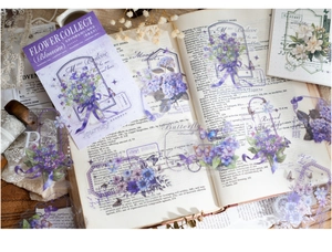 Detail of vintage PET flower stickers with purple blooms and butterflies on old book pages