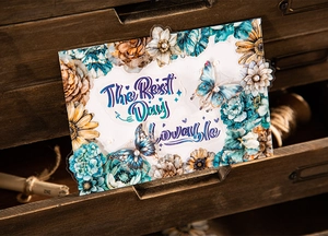 Close-up of vintage floral PET stickers with blue dahlia and butterfly on wood
