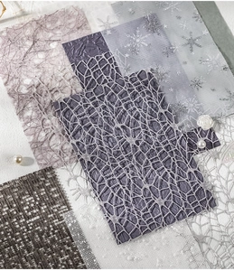 Macro shot of assorted decorative tulle fabrics with silver snowflakes for DIY scrapbooking