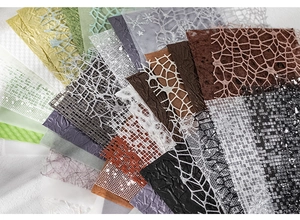 Detailed fan layout of hollow lace mesh and textured paper materials for DIY scrapbooking