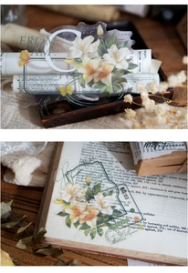 Close-up of vintage PET stickers featuring lily motifs and elegant typography for scrapbooking