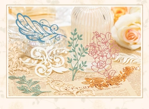 Macro shot of laser-cut floral paper scraps and decorative hollow lace for journaling