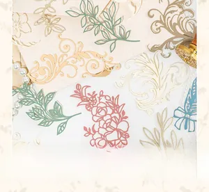 Macro view of vintage lace-style hollowed paper stickers for scrapbooking and DIY journals