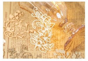 Close-up of intricate lace paper stickers with vintage floral and scroll patterns