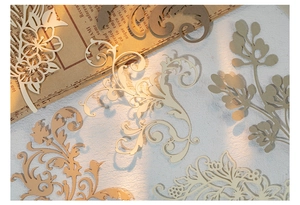 Close-up of laser-cut vintage floral paper scraps for scrapbooking and DIY crafts