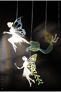 Detail of laser-cut iridescent fairy and mermaid silhouettes for DIY journaling