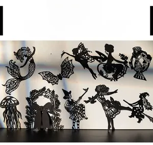 Detail of laser-cut black silhouette stickers featuring mythical fairies and creatures