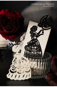 Macro shot of laser-cut black and white silhouette paper crafts with intricate hollow detail