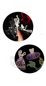 Macro detail of laser-cut silhouette paper stickers featuring witch and fairy designs