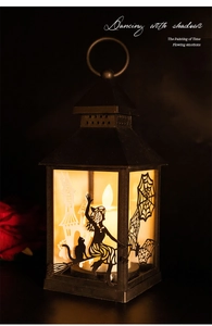 Detail of Halloween silhouette lantern with warm LED candle light and witch design