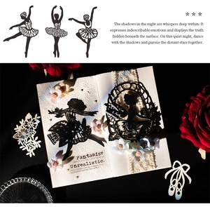 Close-up of ballet dancer silhouettes and butterfly paper cutouts for DIY scrapbooking