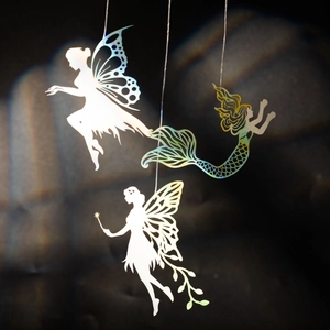 Holographic silhouette hanging ornaments featuring fairies and mermaid with rainbow shadows