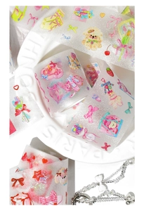 Macro detail of glitter PET decorative tape with cute poodle and bow patterns