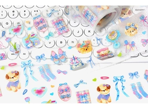 Close-up of glitter PET tape with cute dog, bows and hearts on a white keyboard