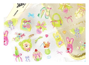 Close-up of glittery PET stickers featuring cute cartoon bears and rabbits for DIY journaling