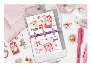 Flat lay of purple transparent binder with cute dog stickers and pink markers for DIY journaling