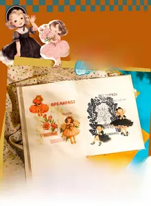Close-up of vintage girl character stickers with lace details on a scrapbook page